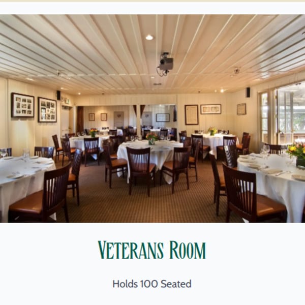 The Veterans Room at MacArthur Park Restaurant, an event space with round tables, white tablecloths, and wooden chairs.